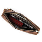 Vintage brown leather wristlet with metal zipper and stitching
